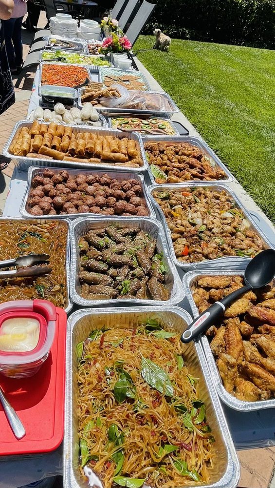 Catering buffet spread with several trays of food
