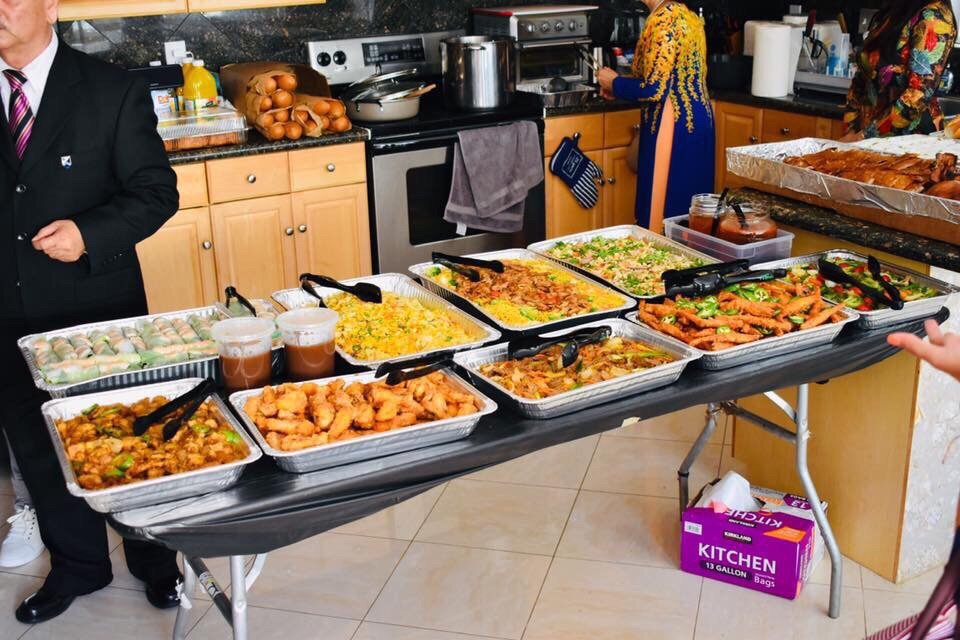 Catering buffet spread with several trays of food